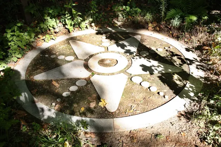 A spiral-shaped permaculture garden bed with mixed plantings
