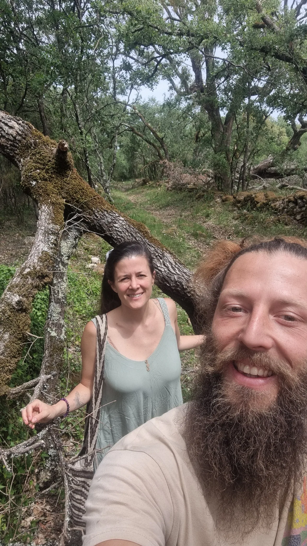 Benjy and Sofia smiling together in a wooded landscape
